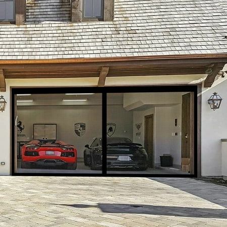 two cars are parked in the garage with their doors open and one car is red