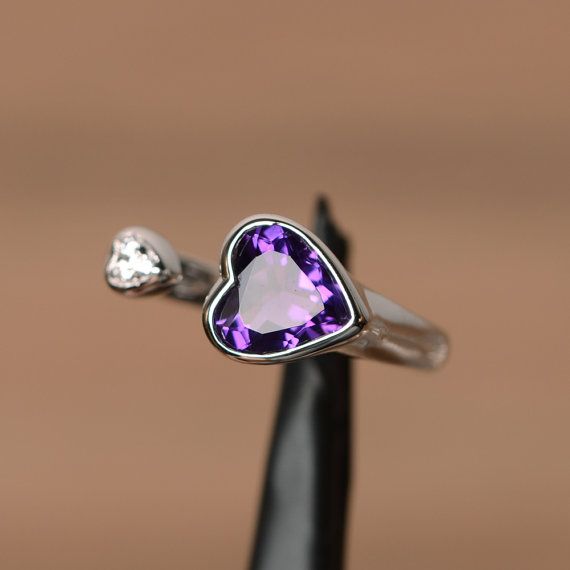 a ring with a heart shaped amethyst stone