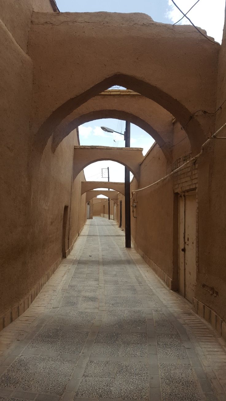 an arched walkway between two buildings