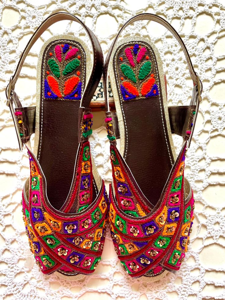 Hand crafted & hand embroidered leather Peshawari Chappal - in 100% leather embellished with Multi Color thread Work & Sequence  Available in UK Size 4, 5 ,  Each item is individually crafted by a unique artisan and reflects his creativity and expression ! A Peshawari Chappal is a Traditional footwear design of Pakistan & takes its name from the city of Peshawar  It is a semi closed footwear consisting of two wide strips which cross over each other to join the sole of the sandal  The Peshawari Chappal has become increasingly popular in the fashion space of Pakistan . The urban youth wear this very often with jeans and Western clothes The Classic style of this shoe make it a perfect accessory for Weddings , Parties and Christmas events. Ideal for  casual and formal wear with both Eastern as Traditional Festive Sandals For Party, Traditional Festive Party Sandals, Traditional Gota Work Sandals For Party, Traditional Party Sandals With Gota Work, Traditional Sandals With Zari Work For Festivals, Traditional Sandals With Dori Work For Festivals, Festive Dori Work Sandals, Traditional Festive Sandals With Zari Work, Traditional Festive Sandals With Dori Work