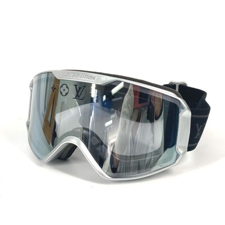 a pair of ski goggles sitting on top of a white surface