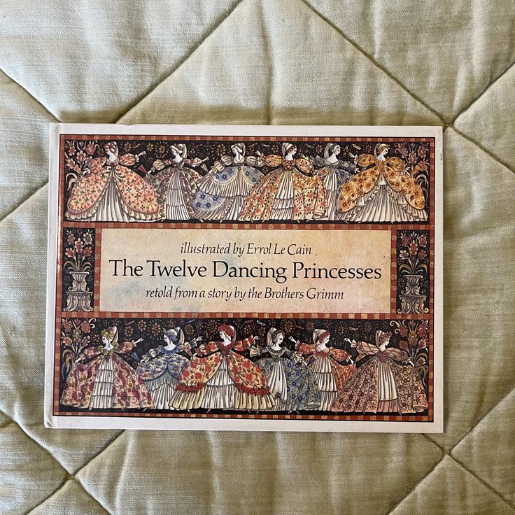 the twelve dancing princesses book is laying on a bed