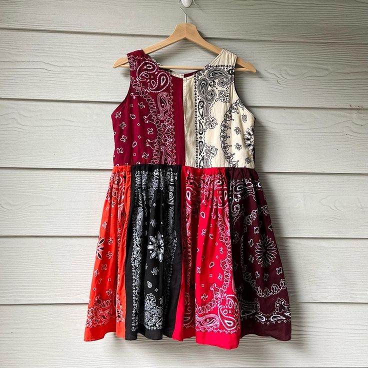 Handmade Sleeveless Cowgirl Bandana Dress SKU 08273 Size: M. Partially lined. -100% cotton. -100% handmade. Approximate measurements laying flat: Pit to pit: 18.5". Pit to hem: 26". Shoulder to hem: 35". Waist: 18". Seen on 5'5" tall. In excellent condition. See pictures for full details. Summer Cotton Sleeveless Dress With Patchwork, Summer Sleeveless Cotton Dress With Patchwork, Red Sleeveless Cotton Sundress, Casual Cotton Sleeveless Dress With Patchwork, Casual Cotton Sleeveless Patchwork Dress, Casual Cotton Patchwork Sleeveless Dress, Bohemian Cotton Sleeveless Sundress, Bohemian Sleeveless Cotton Sundress, Casual Red Cotton Sleeveless Dress