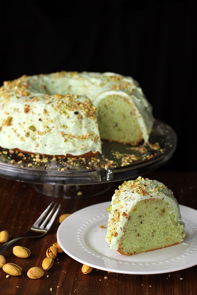 homemade pistachio pudding cake on a white plate