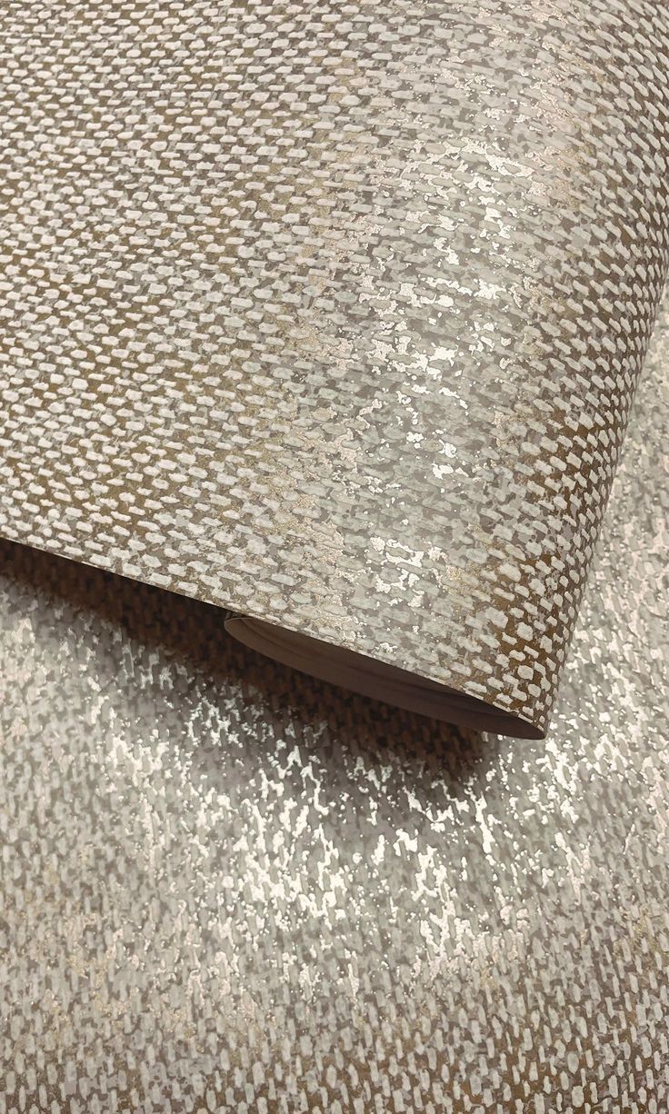 an upholstered fabric with silver and brown patterns