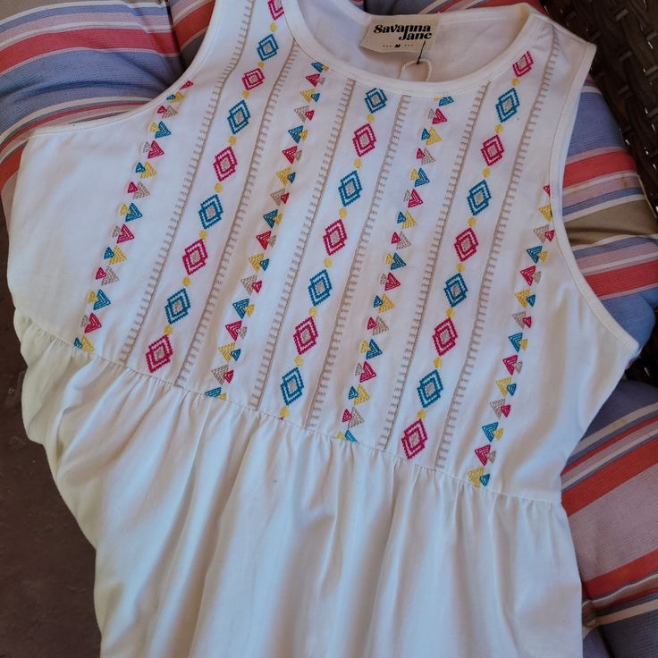 Nwt 100% Soft Cotton Sleeveless Baby Doll Style Top. Embroidered Front, Plain Back. Very Flattering Fit. Hand Wash Cold, Line Dry. Size S (Photo Shows Size M, But I Have Multiple Sizes Avail) White Sleeveless Top With Floral Embroidery, White Floral Embroidered Sleeveless Top, White Sleeveless Embroidered Top, White Sleeveless Embroidered Top For Beach, Sleeveless Cotton Embroidered Beach Top, Sleeveless Embroidered Cotton Top For Beach, White Sleeveless Embroidered Top For Summer, Sleeveless Top With Multicolor Embroidery For Vacation, Sleeveless Tops With Multicolor Embroidery For Vacation