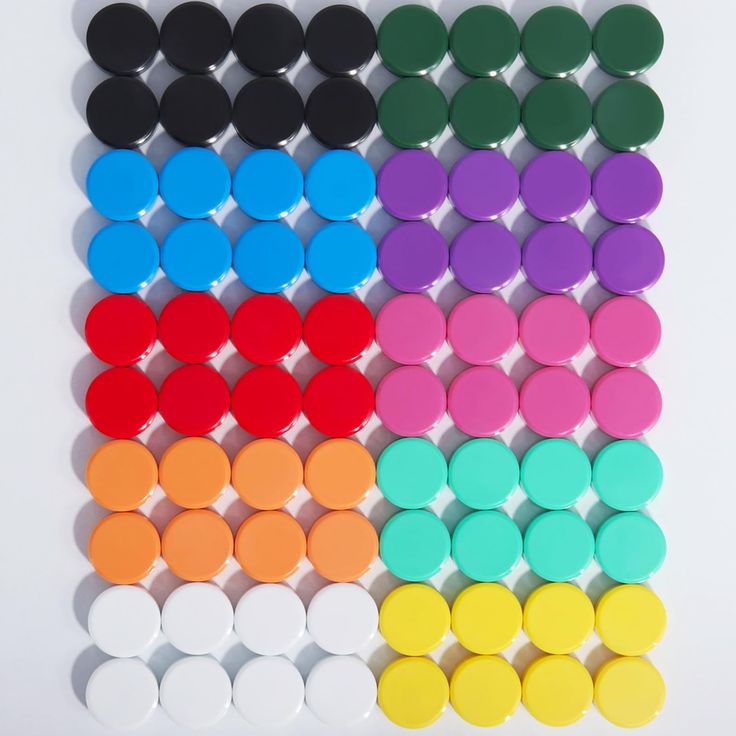 several different colors of buttons on a white background