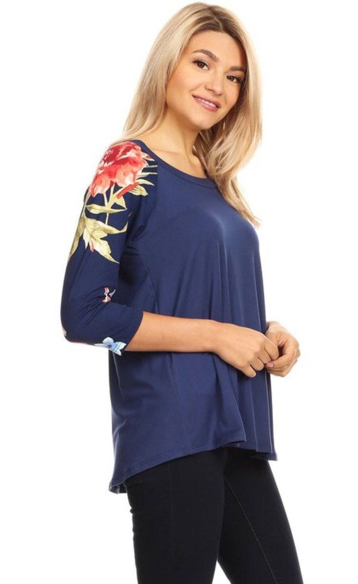 Update your fashion rotation in our trendy floral top for Women. This cute and casual top features 3/4 length floral sleeves and a solid blue center. Created with double brushed fabric, it is extremely soft and comfy. A designer quality shirt every Woman loves to wear. Our blue top for Women is perfect worn alone or layer under a cardigan, duster or jacket. This top also pairs perfectly with any of our buttery soft leggings or jeans. A casual top that is versatile for traveling, running errands Trendy Half Sleeve Beach Tops, Trendy Half Sleeve Tops For The Beach, Blue Half-sleeve Summer Tops, Printed Half Sleeve Tops For Vacation, Navy Stretch Tops For Summer, Trendy Summer Top With 3/4 Sleeves, Trendy Summer Tops With 3/4 Sleeves, Blue Half Sleeve Beach Top, Trendy Navy Summer Tops