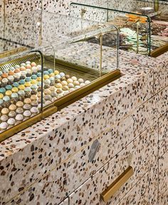 an assortment of cupcakes are on display in the bakery's glass cases