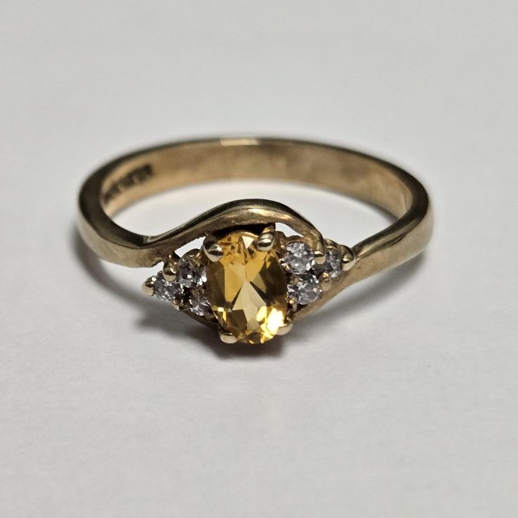 This dazzling 9ct yellow gold ring showcases a beautiful citrine gemstone surrounded by shimmering cubic zirconia accents. The cluster design creates a vintage-inspired look that's perfect for adding a touch of glamour to any occasion. Key Features: Metal: 9ct Yellow Gold (Hallmarked) Gemstones: Citrine & Cubic Zirconia Ring Size: P (UK) Weight: Approximately 2.7 grams Why Choose These Rings?  * Radiant Gemstones: These rings showcase the warm, sunny beauty of citrine.  * High Quality: Crafted w Gem Ring, Cubic Zirconia Rings, Citrine Ring, Citrine Gemstone, Multi Stone, Multi Stone Ring, Favorite Rings, Yellow Gold Rings, Stone Rings