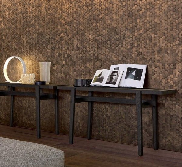 two black tables with pictures on them in front of a wallpapered wall and floor