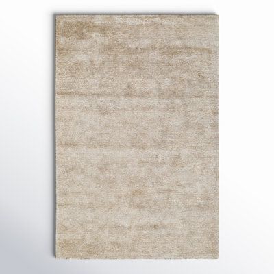 a beige rug on a white background with room for text or image in the center