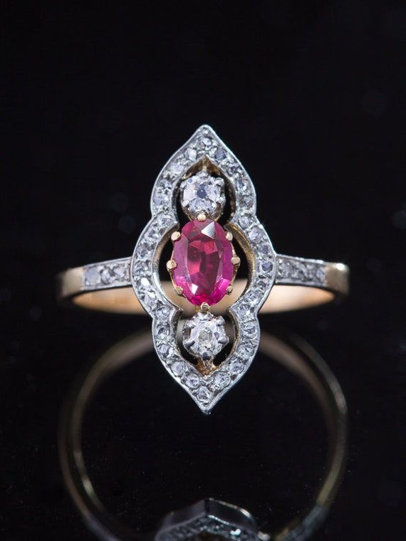 Dream With panache and artistic sensibilities, this north south oriented ring sweeps you away to another time and place. Edwardian aesthetics take precious metals, natural ruby and diamonds to create an item of jewelry art. Sparkling diamonds, luscious red ruby and an unforgettable design sensibility lead to a unique and eye catching statement ring. A beautiful marquise or navette shape characterises this Edwardian ring, outstanding with a line of precious gemstones centered vertically within sw Art Deco Ruby Ring With Diamond Details, Antique Ruby Ring With Single Cut Diamonds, Red Diamond Rings With Rose Cut, Marquise Ruby Ring With Rose Cut Diamonds, Red Platinum Rings With Diamond Accents, Platinum Rings With Red Diamond Accents, Fine Jewelry Red Diamond Ring With Rose Cut, Red Marquise Rose Cut Diamond Rings, Red Marquise Rings With Rose Cut Diamonds