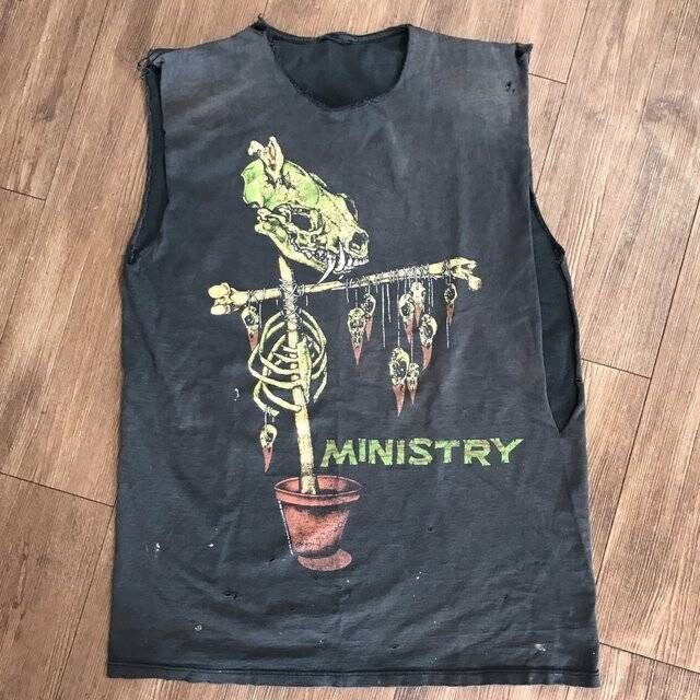 a black shirt with an image of a skeleton holding a potted plant on it