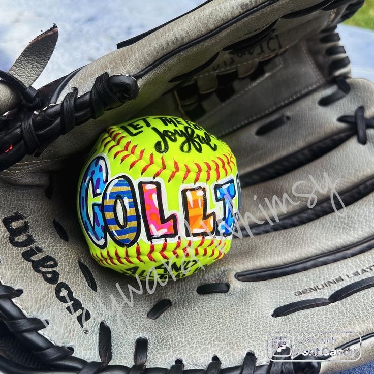 a baseball glove with a ball in it and some writing on the inside of it