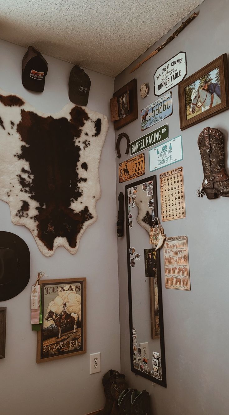 the wall is covered with many different items and signs, including cowhide rugs