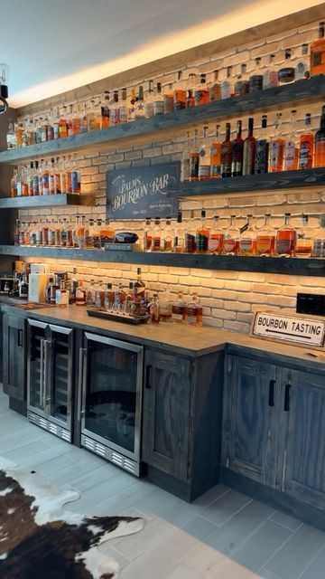 an empty bar with lots of bottles on the shelves and cow hide rug in front of it