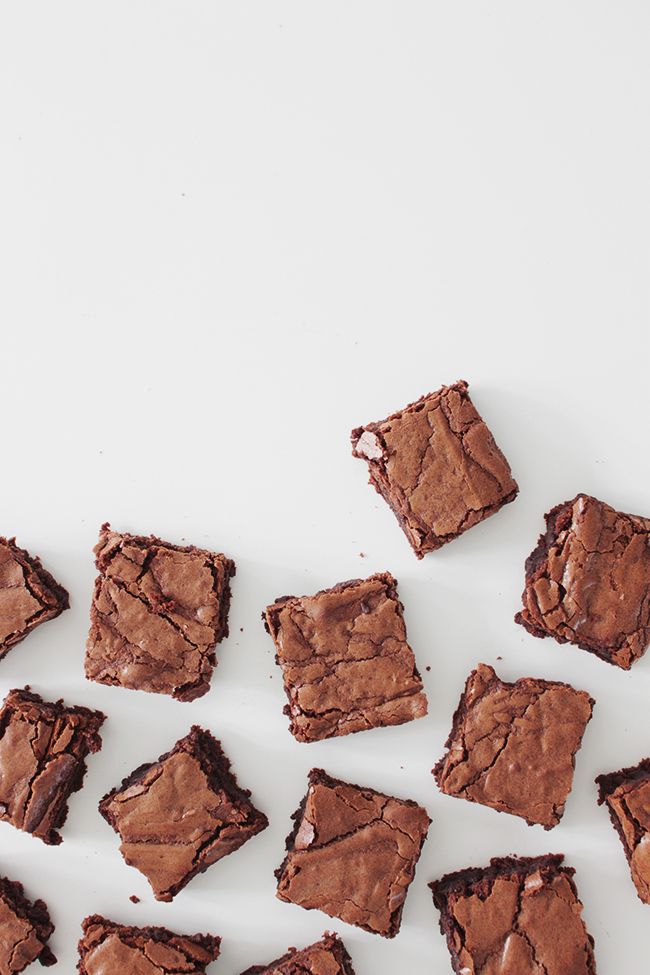 several pieces of brownie sitting on top of a white table next to each other