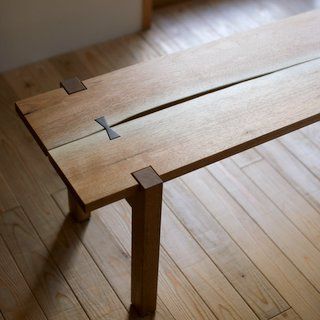 a wooden table sitting on top of a hard wood floor