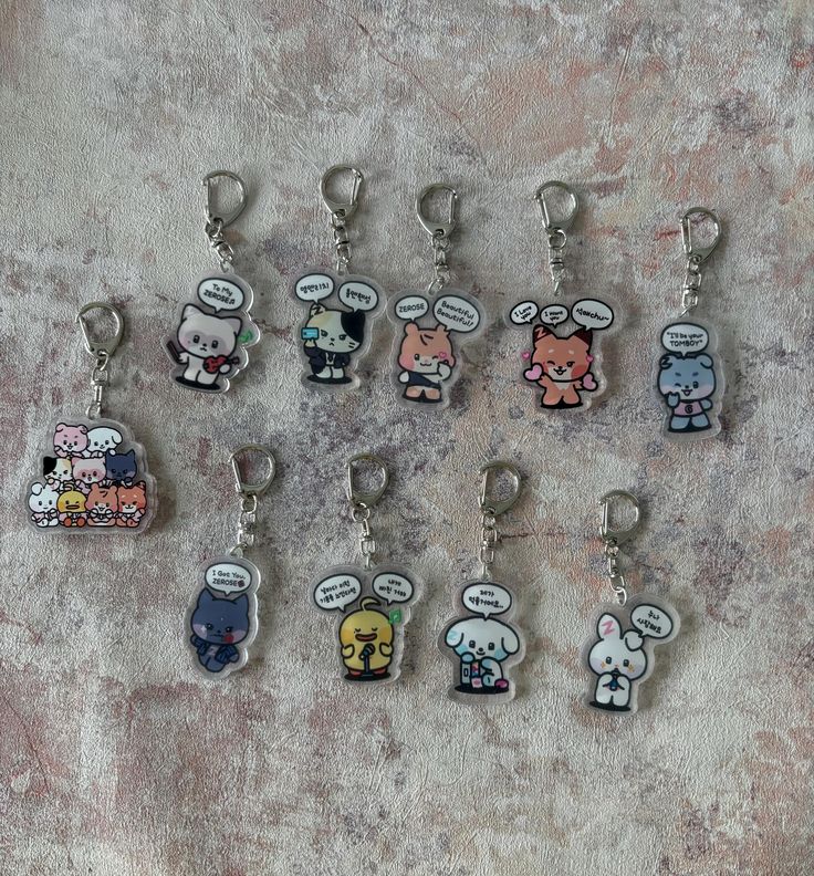 a bunch of keychains with cartoon characters on them sitting next to each other