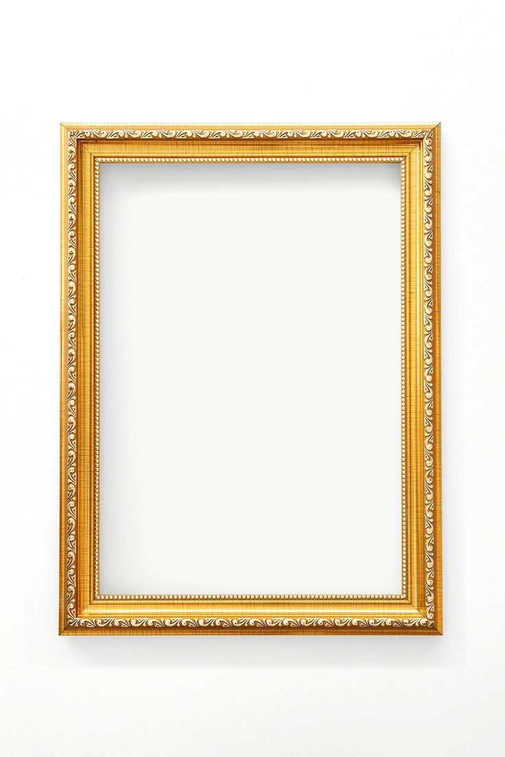 an empty gold frame hanging on the wall