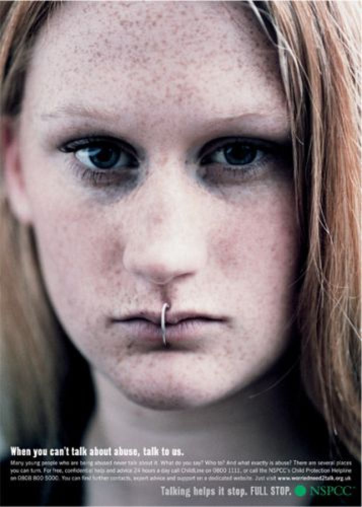 a woman with freckles on her nose and nose ring in front of her face