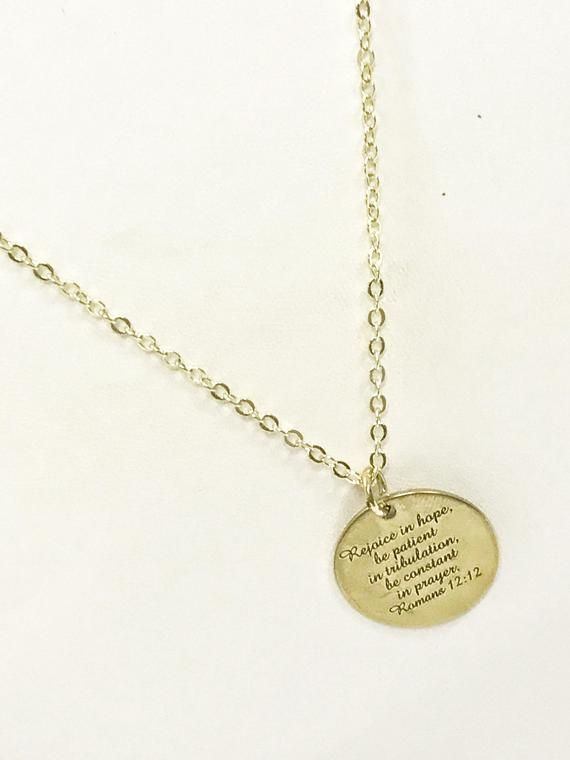 PLEASE NOTE THAT DUE TO SIGNIFICANT POSTAL DELAYS CURRENTLY BEING EXPERIENCED, ORDERS PLACED AFTER DECEMBER 9TH MAY NOT ARRIVE IN TIME FOR CHRISTMAS.  This is a gold plated necklace with a gold plated stainless steel laser engraved pendant with "Rejoice in hope, be patient in tribulation, be constant in prayer" from Romans 12:12 on it.  This pendant is available on your choice of 16, 18, 20, 22, 24, 26, 28 or 30 inch chain. This jewelry item has small parts and is not intended for anyone under t Spiritual Gold Hand Stamped Jewelry, Gold Hand Stamped Spiritual Jewelry, Gold Spiritual Hand Stamped Jewelry, Inspirational Gold-toned Stainless Steel Jewelry, Spiritual Laser Engraved Gold Jewelry, Spiritual Gold Laser Engraved Jewelry, Laser Engraved Spiritual Gold Jewelry, Spiritual Gold Jewelry Laser Engraved, Gold Spiritual Jewelry Laser Engraved