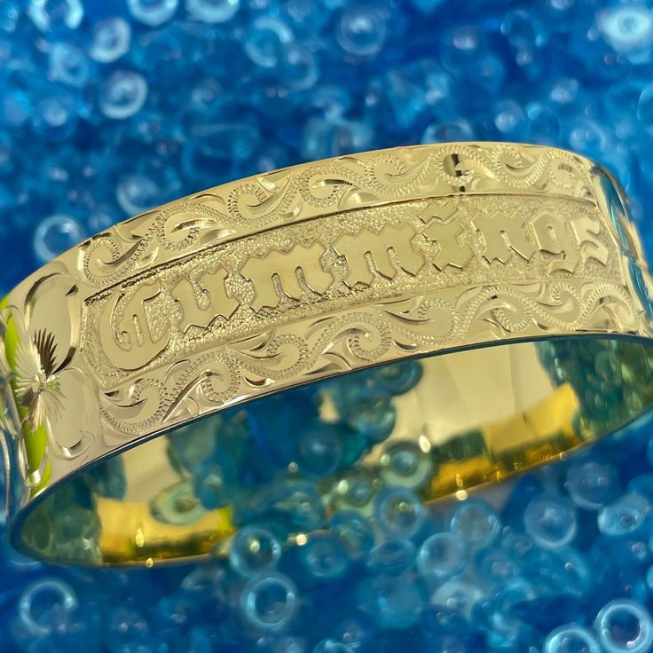 Locally Handmade. Please Allow 3-5 weeks for delivery. You will love and cherish these Custom Hawaiian Scroll Bangles. The Hawaiian Scroll Design is hand engraved by a local Master Engraver. Free Engraved Name in Black Enamel or Raised Gold lettering is included! It is beautiful, one-of-a-kind and custom made especially for YOU!! Our customers tell us these look just like the solid gold pieces they have - but we've made them affordable with 14K Gold Plating over .925 Sterling Silver. 6mm ~ $249 Engraved Adjustable Gold Bracelet, Adjustable Engraved Gold Bracelet, Heirloom Engraved Cuff Bracelet, Engraved Bangle Bracelet For Personalized Gift, Adjustable Heirloom Bracelets For Anniversary, Adjustable Etched Bracelets For Anniversary, Heirloom Style Handmade Bracelet For Gift, Handmade Gold Promise Bracelets, Etched Round Bracelet As Gift