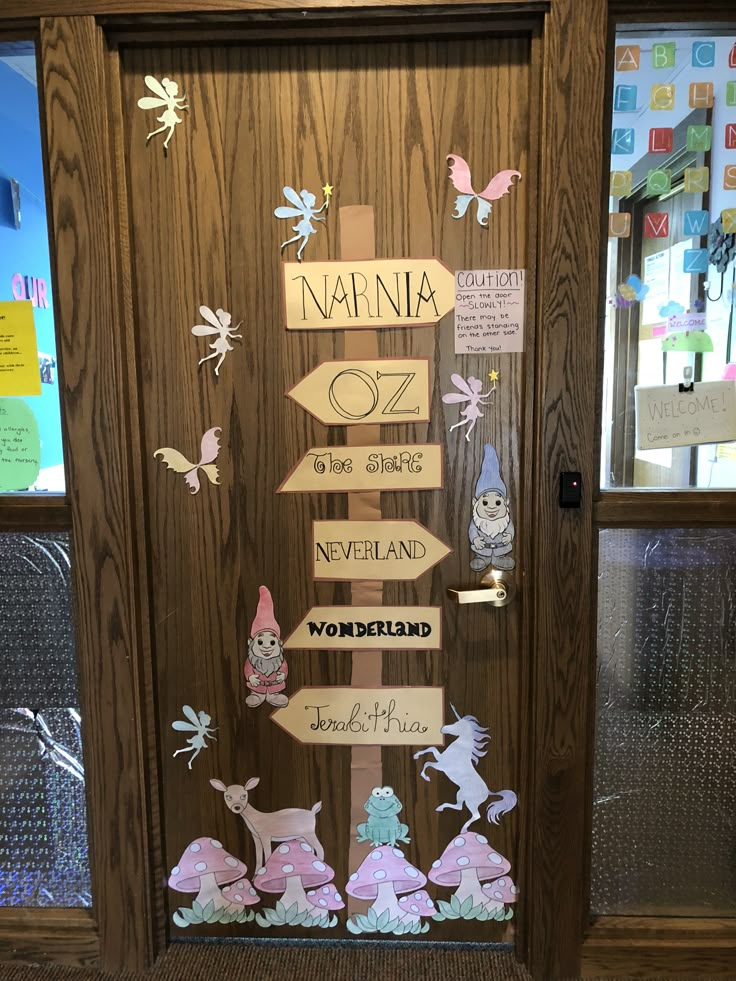 a door decorated with wooden signs and fairy characters