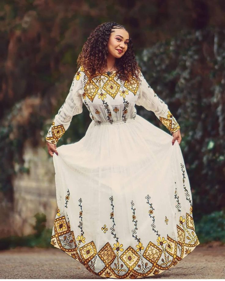 This Habesha Kemis, a traditional Ethiopian garment, exudes an exquisite blend of simplicity, elegance, and cultural heritage. Handwoven with meticulous care, this dress represents the rich craftsmanship and artistry deeply ingrained in Ethiopian culture. Starting with the handwoven fabric, skilled weavers spend countless hours creating a textile masterpiece. Using traditional looms and techniques passed down through generations, vibrant threads are meticulously worked into intricate patterns th Habesha Kemis Modern, Ethiopian Wedding Dress, Xhosa Attire, Ethiopian Culture, Eritrean Dress, Beautiful Ethiopian, Ethiopian Wedding, Habesha Dress, Ethiopian Traditional Dress