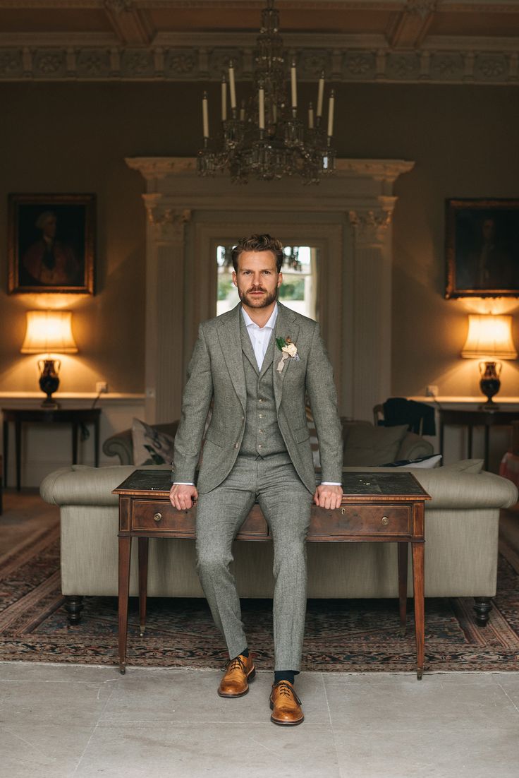 a man in a suit sitting on a table