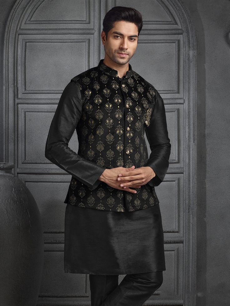 A velvet Nehru jacket paired with a black silk kurta pajama exudes a refined, regal look. The Nehru jacket, tailored in luxurious velvet, features a sleek, high-collar silhouette with a row of elegant buttons down the front. Its deep black hue adds a sophisticated touch, while the soft texture of the velvet enhances the jacket's opulence. Underneath, the silk kurta in matching black flows gracefully, offering a subtle sheen that complements the rich velvet. The kurta is simple yet elegant, paired with pajama pants in the same silky material, creating a monochromatic, seamless ensemble perfect for formal occasions. Indian vest, vest with kurta, Eid dress,kurta pyjama,diwali kurta pyjama,wedding kurta COST INCLUDES JACKET WITH KURTA PYJAMA Luxury Nehru Jacket With Naqshi For Reception, Luxury Self Design Nehru Jacket For Men, Black Nehru Jacket With Zari Work For Festivals, Black Nehru Jacket With Zari For Festivals, Traditional Black Nehru Jacket For Festive Season, Festive Black Nehru Jacket, Black Nehru Jacket With Dabka For Eid, Black Nehru Jacket For Festivals, Black Long Sleeve Nehru Jacket For Diwali