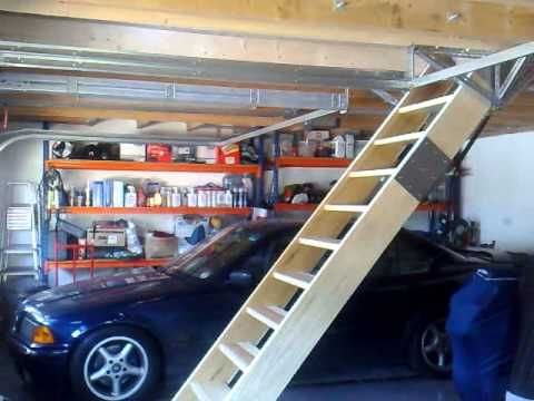 there is a car in the garage with a ladder on it's back end