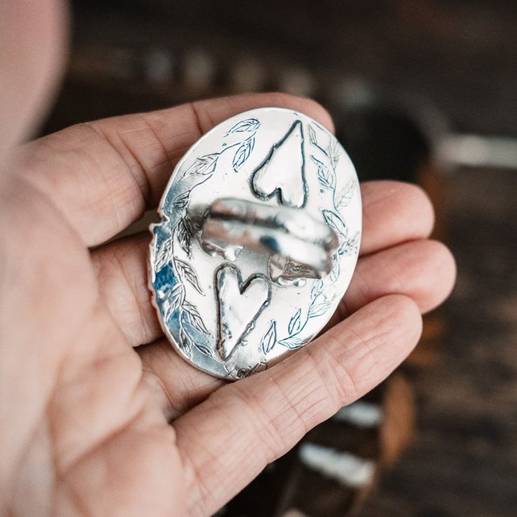 Shine like the moon with this stunning organic Dendritic Opal pendant with hearts etched on the back. This is a big, bold one! One of a Kind- Size 9.25 - Not Sizable Dendritic Opal Size 9.25 - Not sizable Sterling Silver One of Kind Made with hand and heart Unique Stamped Ring Jewelry, Artisan Engraved Heart Jewelry, Artisan Engraved Heart-shaped Jewelry, Nature-inspired Round Etched Jewelry, Unique Etched Pendant Jewelry, Unique Etched Round Jewelry, Etched Silver Nature-inspired Jewelry, Etched Nature-inspired Silver Jewelry, Nature-inspired Etched Silver Jewelry