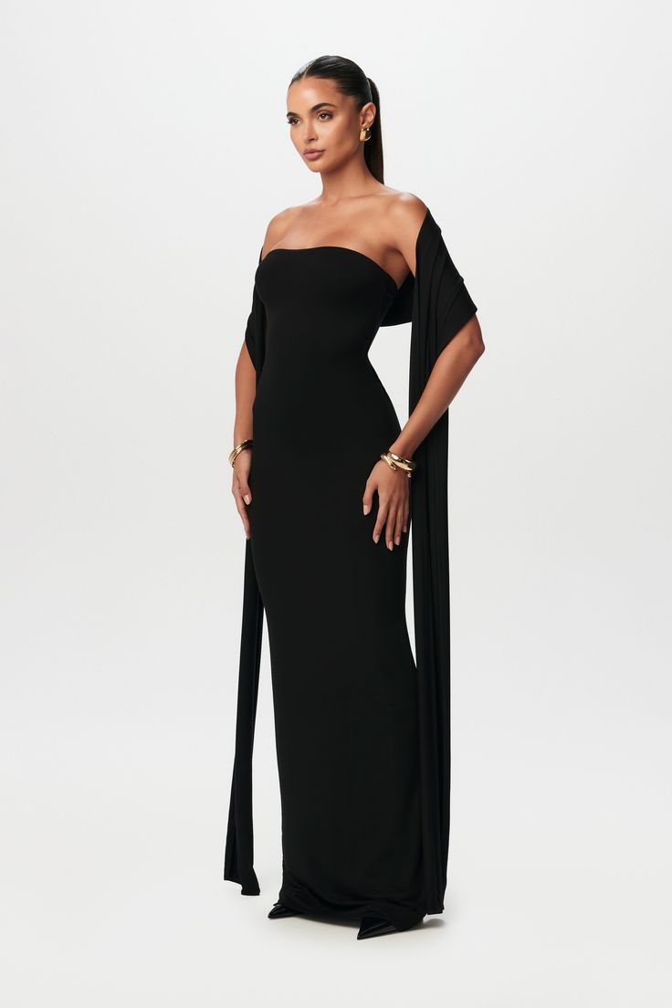 Simplicity meets sophistication in our vacay-inspired set. Designed with a tube and double-lined bodycon structure with a detachable scarf to wrap around your head or relax along your arms. Smooth Collection Import 92% Viscose Rayon, 8% Spandex Model wears size X-Small True to size Double-lined Classy Black Dress Black Women, Corset Tie Back Dress, All Black Wedding Aesthetic, Black Long Elegant Dress, Graduation Dress Under Gown, Prom Dresses With Scarf, Birthday Guest Outfit Classy, How To Style A Scarf With A Dress, Classy Black Dress Formal