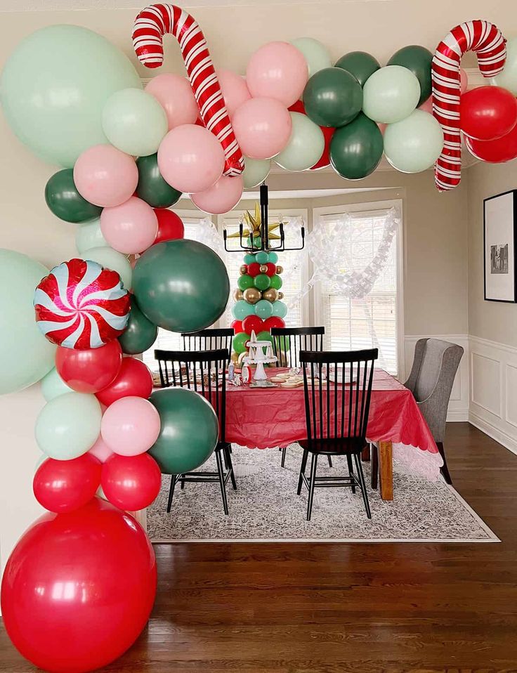 the balloon arch is decorated with candy canes and lollipops