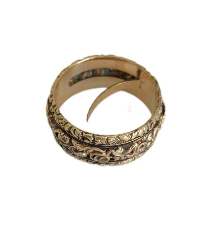 This rare Georgian gold band from around 1820 is a masterpiece, intricately hand-chased with flowers and foliage, showcasing exceptional craftsmanship. The unique feature of a hidden compartment, accessible from within, adds an intriguing element. Inside, a well-preserved lock of woven hair speaks to the sentimental nature of the era. Originating from England and unmarked but tested as 18 karat gold, the band is a size L 1/2 UK (6.25 US) with a width of 8mm. Despite its age, the ring remains in Antique Yellow Gold Engraved Carved Ring, Antique Style Carved Engraved Yellow Gold Ring, Antique Carved Engraved Yellow Gold Ring, Antique Carved Yellow Gold Engraved Ring, Traditional Engraved Yellow Gold Ring, Victorian Gold Engraved Ring With Decorative Band, Victorian Engraved Yellow Gold Ring For Ceremonial Occasion, Traditional Carved Engraved Wedding Ring, Traditional Yellow Gold Jewelry With Decorative Band