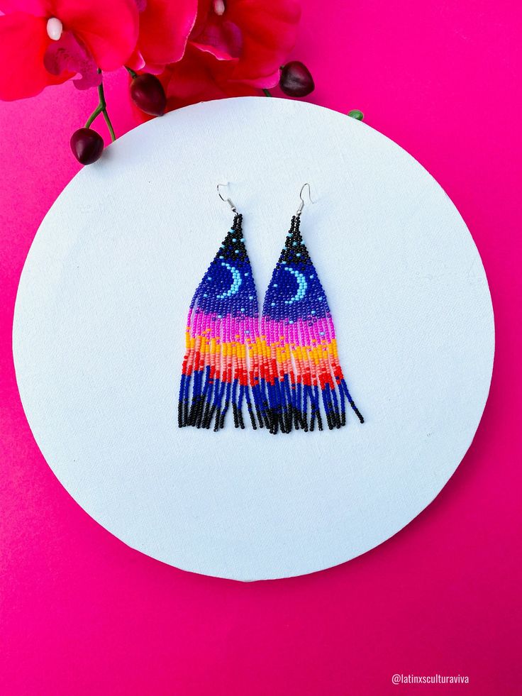 These beautiful beaded earrings are so colorful and perfect for all-day wear. They are definitely the perfect accessory to style up your look and add personality to your outfit. These lovely handmade earrings are made with sterling silver hooks and colorful beads. Each pair of earrings that we sell is authentic and one-of-a-kind! Finds more styles at https://www.etsy.com/shop/LatinxsCulturaViva?ref=simple-shop-header-name&listing_id=990207426&section_id=26730499 Thank you so much for vis Multicolor Beaded Flower Earrings For Festivals, Artsy Beaded Earrings For Pierced Ears As Gift, Artsy Multicolor Beaded Earrings As Gift, Artistic Multicolor Beaded Dangle Earrings, Multicolor Whimsical Earrings, Whimsical Multicolor Festival Earrings, Adjustable Multicolor Whimsical Flower Earrings, Artsy Beaded Drop Earrings, Whimsical Beaded Earrings With Dangling Beads For Gifts