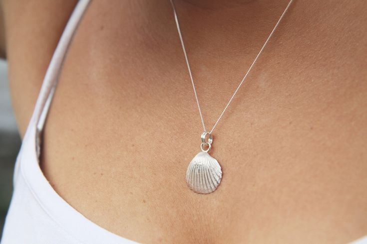 "These little shells were hand collected from the Balearic coast and used to created moulds to cast these fine silver earring and pendant set.  It's the perfect gift for the Thalassophile in your life 🌊  18\" sterling silver chain and earring posts Fine silver shells 🐚" Handmade Silver Shell Pendant, Sterling Silver Shell-shaped Gift, Handmade Silver Pendant Shell, Sterling Silver Shell Pendant Necklace As Gift, Handmade Sterling Silver Shell-shaped Necklace, Silver Shell-shaped Jewelry Gift, Silver Sterling Silver Shell Pendant Necklace, Handmade Silver Round Shell, Handmade Silver Shell As A Gift