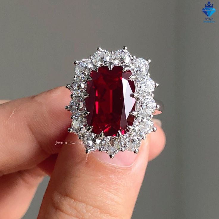 4.20CT Cushion Cut Red Ruby Gemstone Wedding Gift Ring Vintage Style White Gold Halo Engagement Ring, Art Deco Promise Ring Anniversary Gift, Gift Ring for Her, Round Cut Wedding Ring, White/Yellow/Rose Gold Moissanite Ring, Handmade Ring, Moissanite Engagement Ring , Moissanite Wedding Ring, Propose Ring, Wedding Ring Set, Moissanite Jewelry, Fine Jewelry, Custom Ring, Daily Wear Ring, Statement Ring, Perfect Gift for Her ✥ Product Information ✥ ✦ Center Stone: ( D: Simulated Diamond ) ✦ Stone Shape: Cushion Cut ✦ Stone Color: Ruby Red ✦ Weight: 4.20 CT ✦ Main Stone Size : 14X9MM ✦ Cut Grade: Excellent(VVS) ✦ Side stones: ( M: Moissanite Diamond ) ✦ Cut: Round Cut ✦ Weight: 1.20 CT ✦ Stone Color: White(D) ✦ Clarity: Excellent(VVS) ✥ You Will Receive ✥ ♦ Engagement ring ♦Jewelry Box ✥ Imag Elegant Ruby Wedding Ring With Halo, Elegant White Ruby Ring For Wedding, White Diamond Ruby Wedding Ring, Elegant Diamond White Ruby Ring For Wedding, Red Wedding Cluster Ring With Brilliant Cut, White Diamond Ruby Ring For Wedding, White Gold Ruby Ring With Halo For Wedding, Red Brilliant Cut Cluster Ring For Wedding, Formal Ruby Ring With Diamond Halo