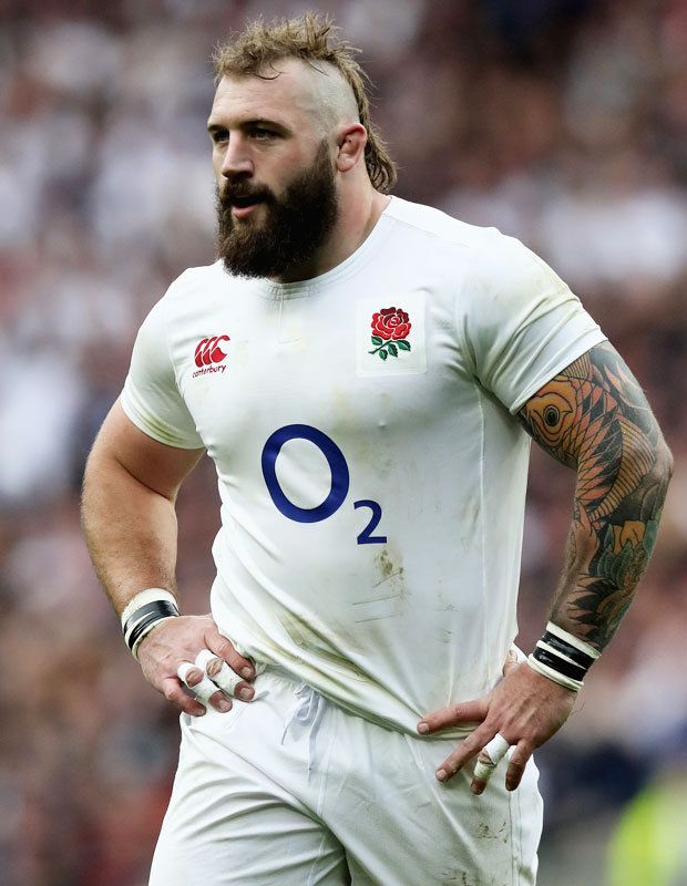 a man with a beard wearing a rugby uniform