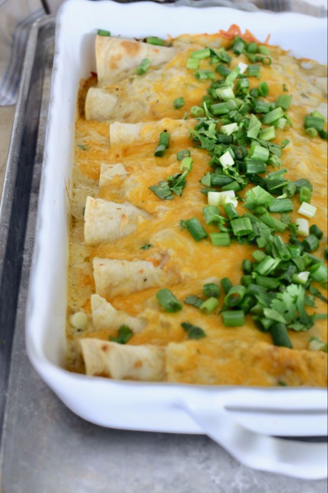 a casserole dish with cheese and green onions