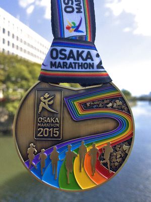 an olympic medal hanging from the side of a river