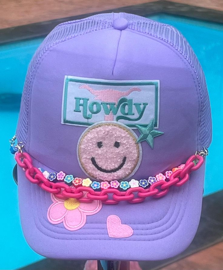 a purple hat with a smiley face on it