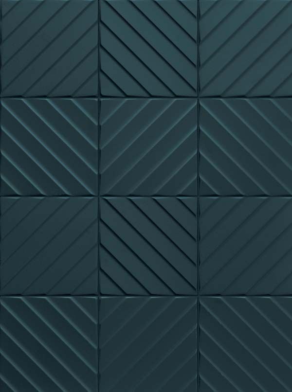 a black tile wall with diagonal lines on it