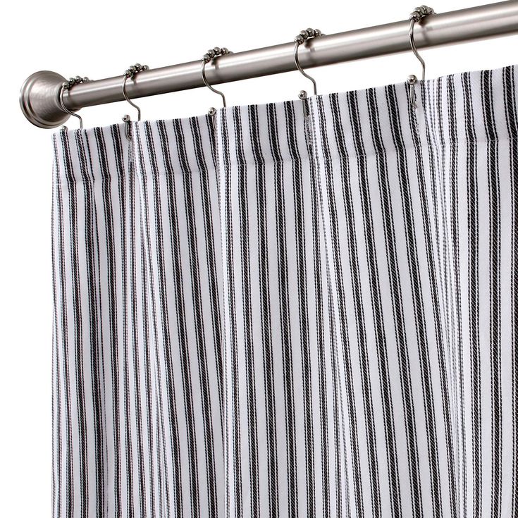 a striped curtain hanging on a metal rod next to a white and black stripped curtain