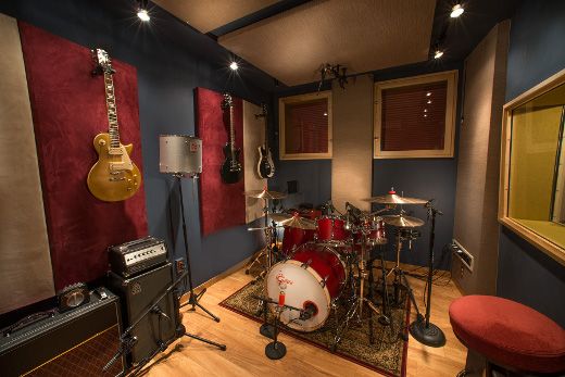 a room with guitars, amps and other musical equipment