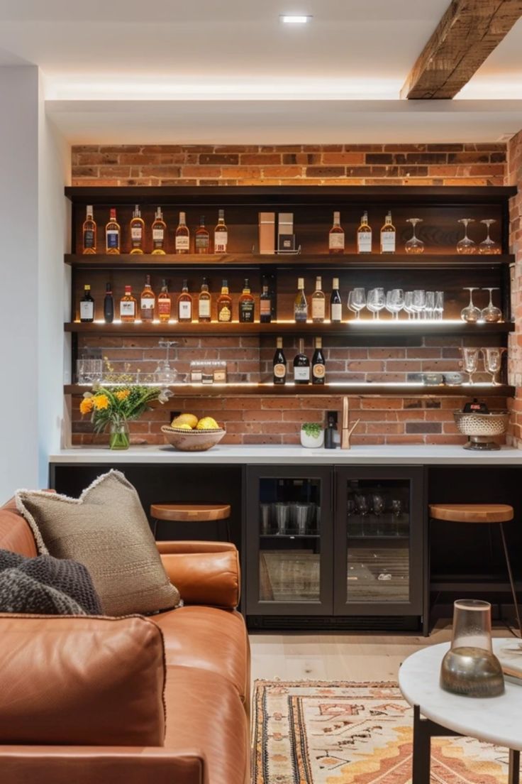 a living room filled with furniture and lots of bottles on the shelves above it's bar