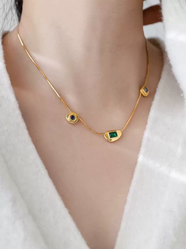 Elevate your style with this exquisite 18k gold-plated necklace, featuring a stunning array of colored gemstones. Each gemstone is meticulously set in a unique bezel, designed to showcase its natural brilliance and color. Crafted with precision, the necklace is made from durable, non-fading stainless steel, ensuring longevity and resistance to tarnish. The harmonious blend of green, blue, and clear gemstones offers a modern yet timeless appeal, making it the perfect statement piece for both everyday wear and special occasions. The sleek, minimalist chain adds a touch of elegance, allowing the colorful gemstones to take center stage. Details: Material: Non-fading stainless steel, 18k gold-plated Gemstones: Multi-colored gemstones (green, blue, clear) Design: Unique bezel settings for each g Gold Plated Gold Necklace With Stones, Gold-plated Birthstone Necklace With Gemstones, Elegant Gold Plated Stone Necklaces, Elegant Gold-plated Necklaces With Stones, Elegant Gold Plated Necklaces With Stones, Elegant Gold Plated Necklaces With Gemstone Accents, Elegant Gold Plated Necklace With Gemstone Accents, Gold Emerald Necklace With Jewels In Fine Jewelry Style, Elegant Gold-plated Necklace With Gemstone Accents