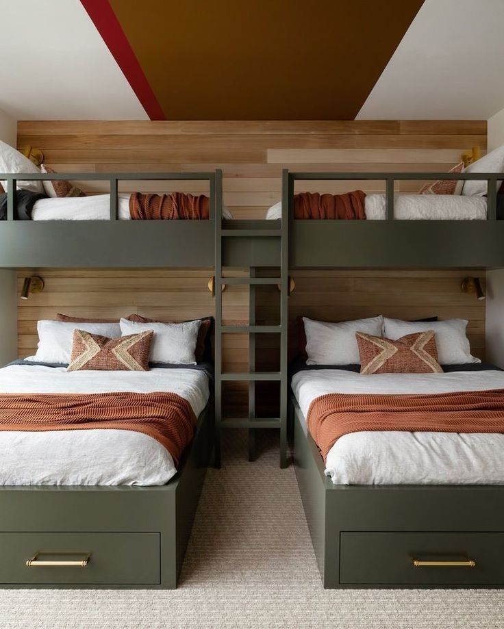 two bunk beds in a room with wooden walls